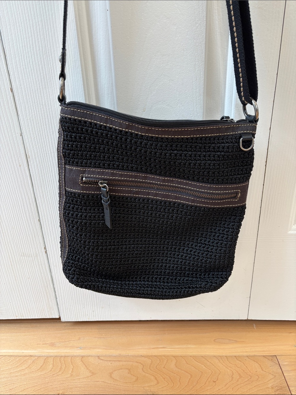 The Sak Lucia Black Crocheted Exterior with Brown Logo Patch Crossbody Bag